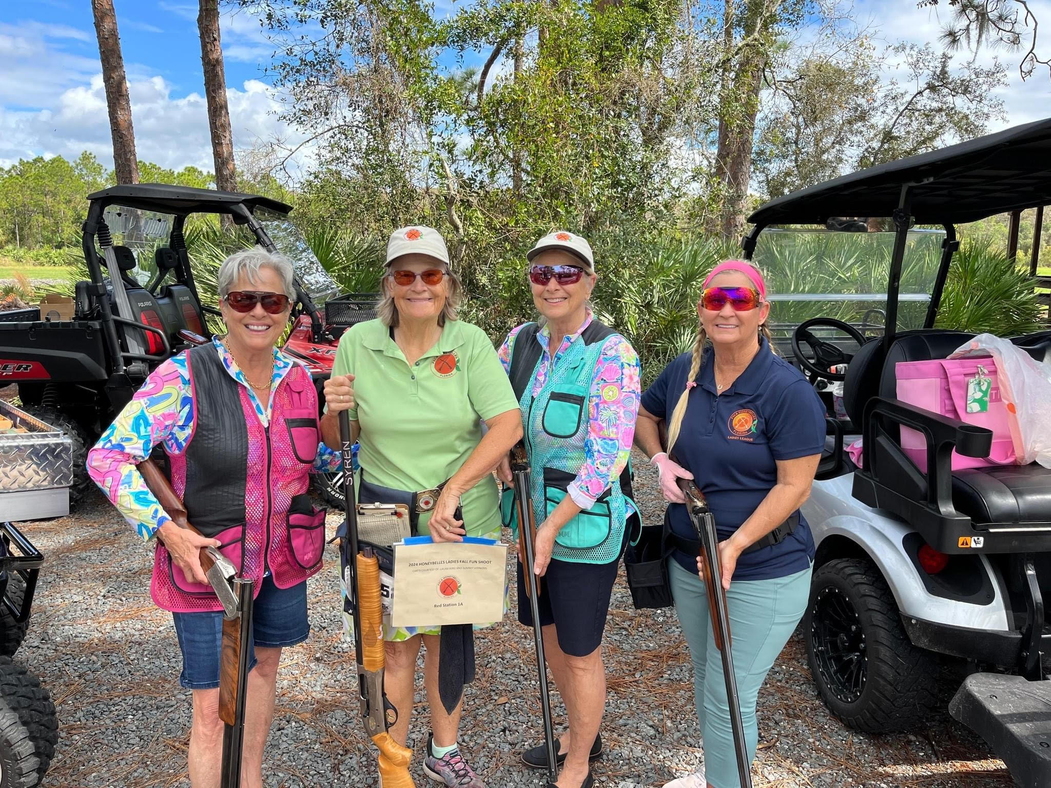 Laura King, a renowned sports performance coach, and team stands confidently at a clay shooting event, emphasizing peak mental and physical preparation for athletes.